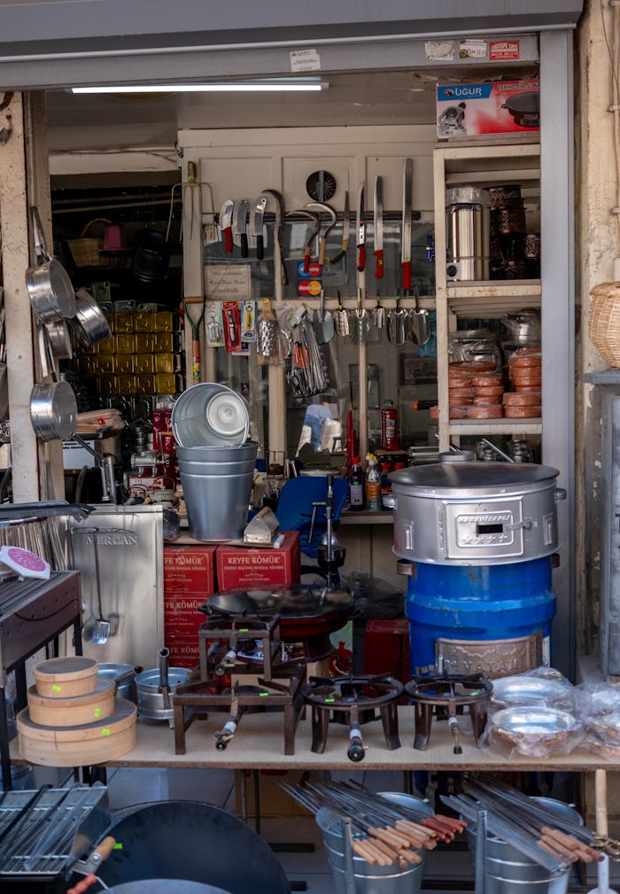 collection-01 A variety of cooking utensils and tools displayed in a vibrant street shop.